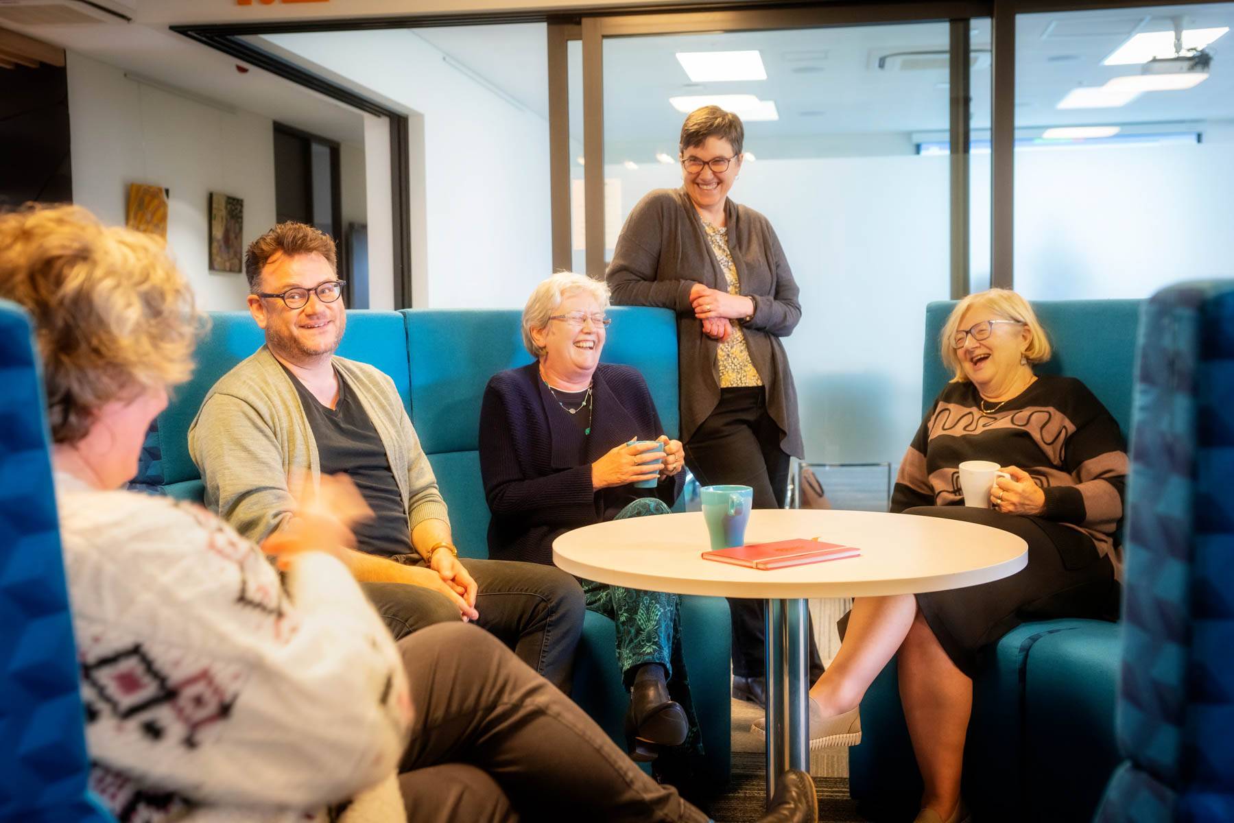 Several Uniting College for Leadership and Theology students sit around a table