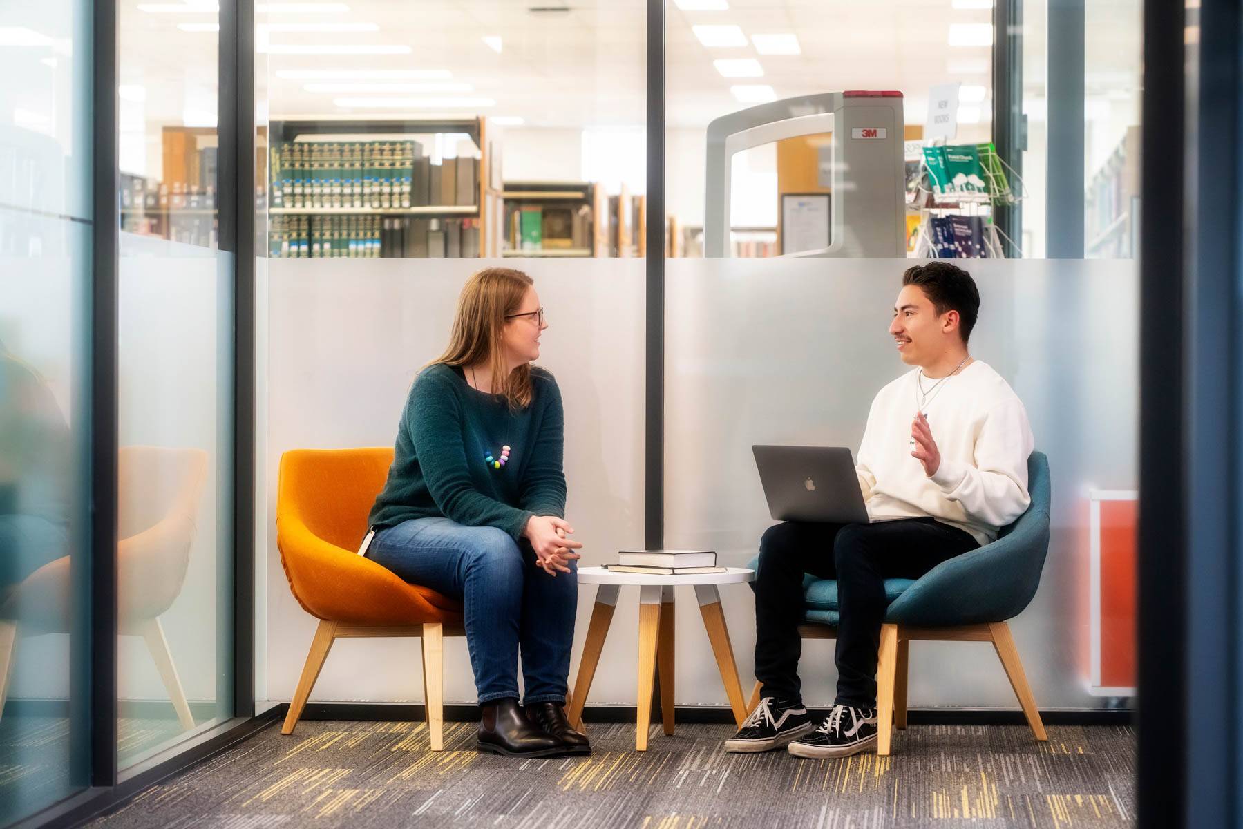 Uniting College for Leadership and Theology students chat in a library room