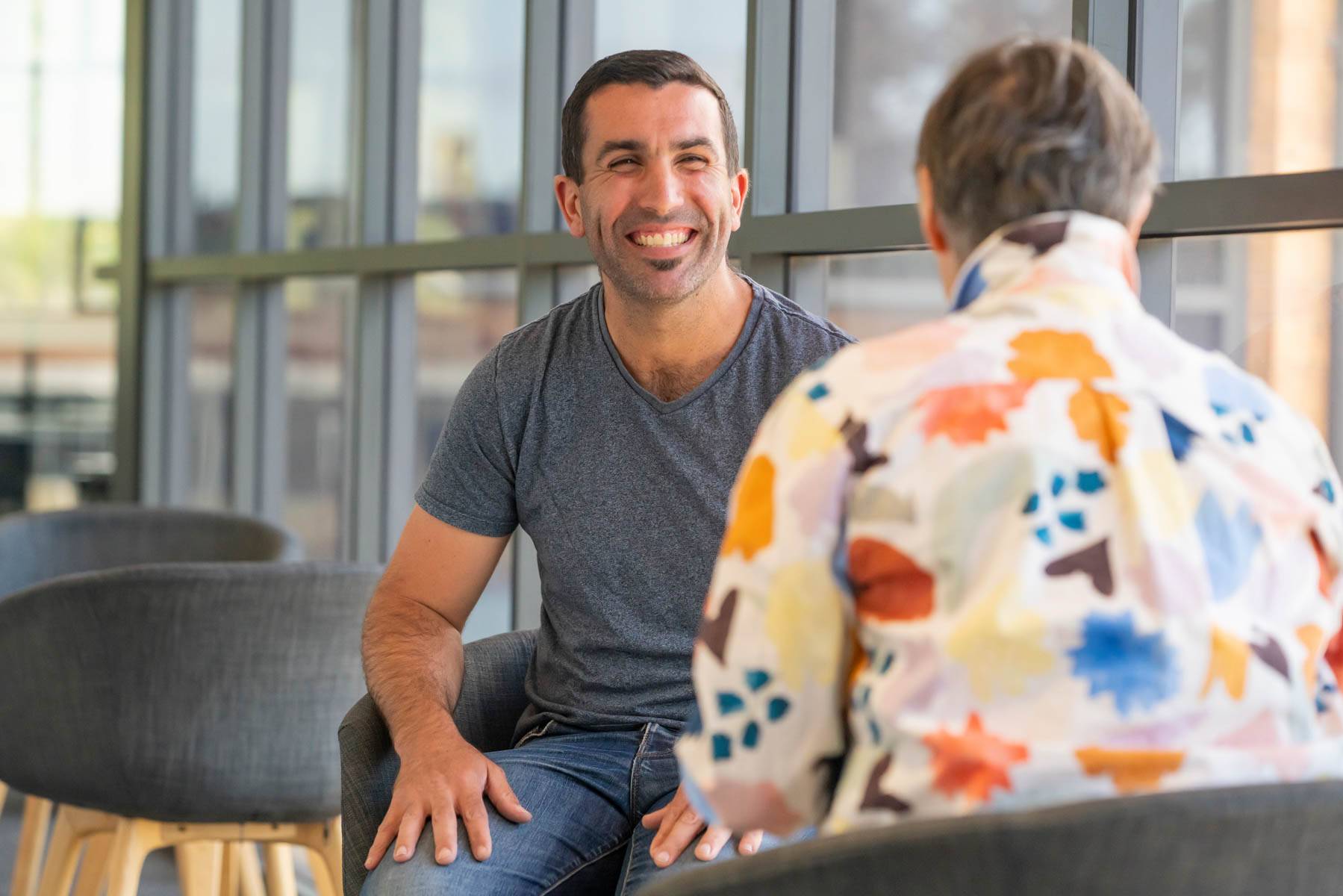 Uniting College for Leadership and Theology student grins at another student as they sit together